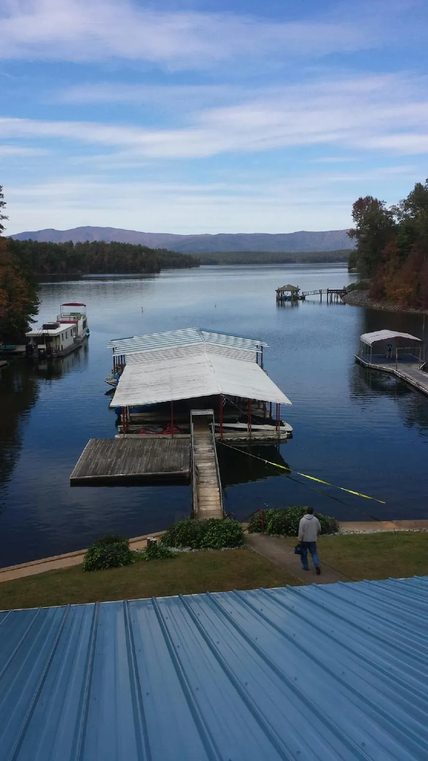 View across a lake from a newly installed blue metal roof in Butler